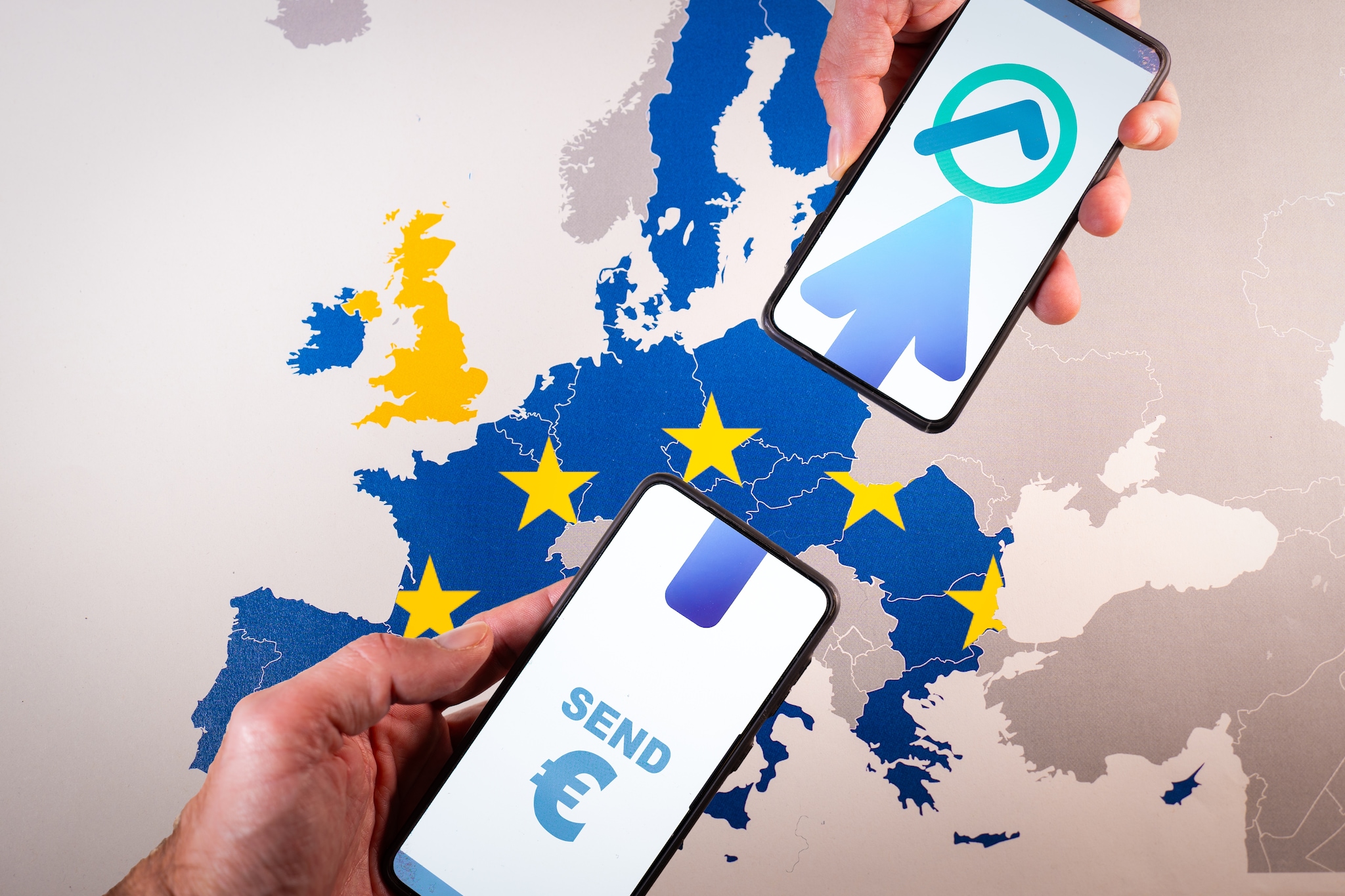 Smartphone screens displaying euro symbol and transfer icon over map of Europe, symbolizing The Instant Payments Regulation tand Ensuring euro money transfers arrive within ten seconds Shutterstock