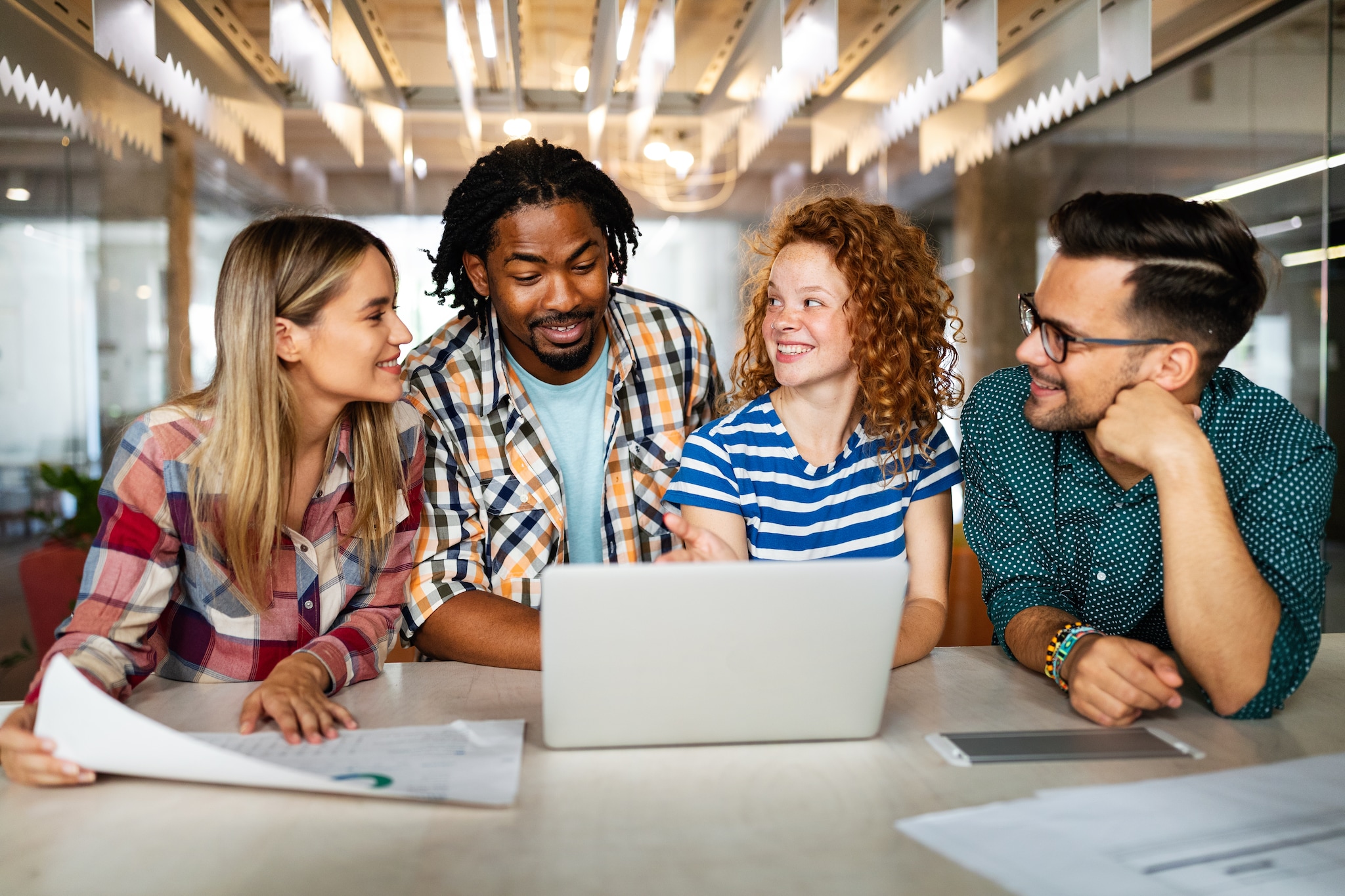 Successful company with happy employees in modern office Shutterstock