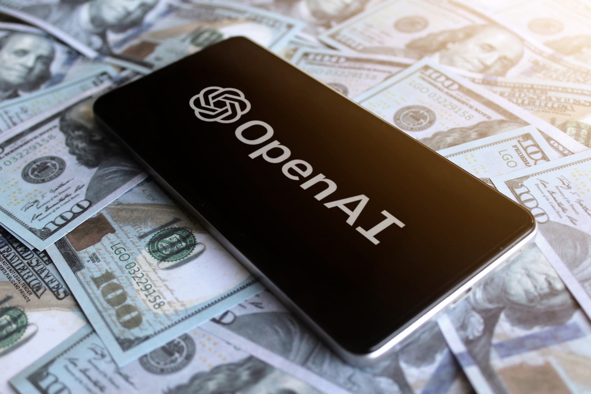 Kedah, Malaysia- May 5th 2023: OpenAI logo displayed on smartphone on top of pile of money. Shutterstock