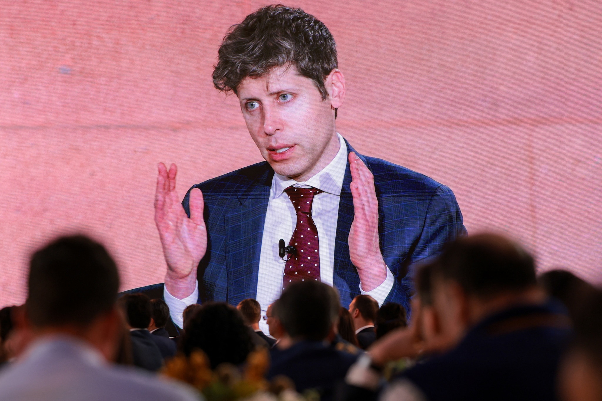 A screen displays CEO of OpenAI Sam Altman speaking during the 2026 Infrastructure Summit of government officials, corporate executives, and labor leaders, in Washington, D.C., U.S., March 11, 2026. REUTERS/Kylie Cooper