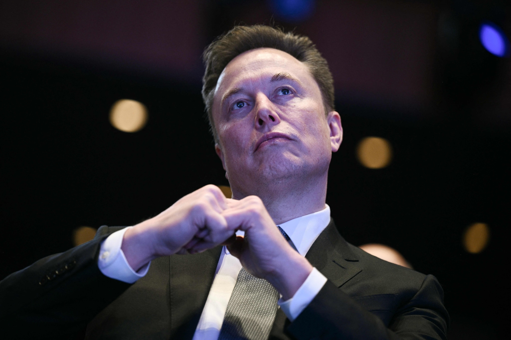 (FILES) Elon Musk looks on as US President Donald Trump speaks at the US-Saudi Investment Forum at the John F. Kennedy Center for the Performing Arts in Washington, DC on November 19, 2025. Tech tycoon Elon Musk offered on March 21, 2026, to pay security personnel at US airports during a political standoff over funding for the Department of Homeland Security (DHS). The lapse in funding has led to longer-than-usual lines at airport security checks, where employees of the Transportation Security Agency (TSA) have been working without pay since mid-February. (Photo by Brendan SMIALOWSKI / AFP)